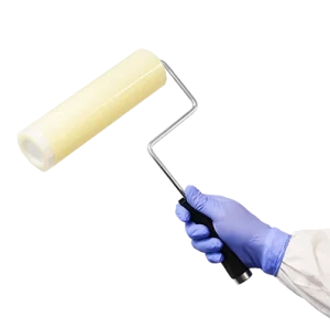Cleanroom film roller in use - with handle - being held by cleanroom operative